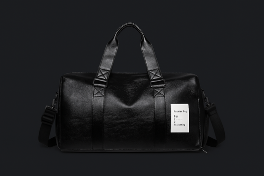 Black leather duffel bag with a visible brand label on a black background