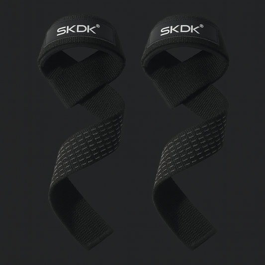 Two black wrist wraps with 'SKDK' branding on a dark background
